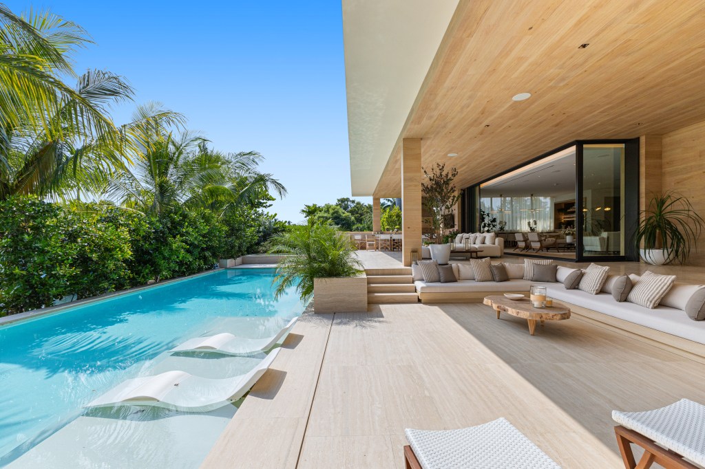 Luxury aquatic property at 1510 W. 23r at Sunset Island III, displaying a swimming pool with hall chairs and deck chairs